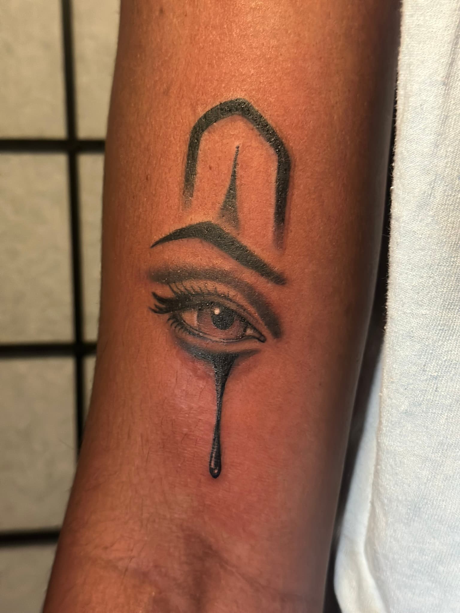 Chicano style chola eye tattoo, black and grey, by Isaac Mackenzie