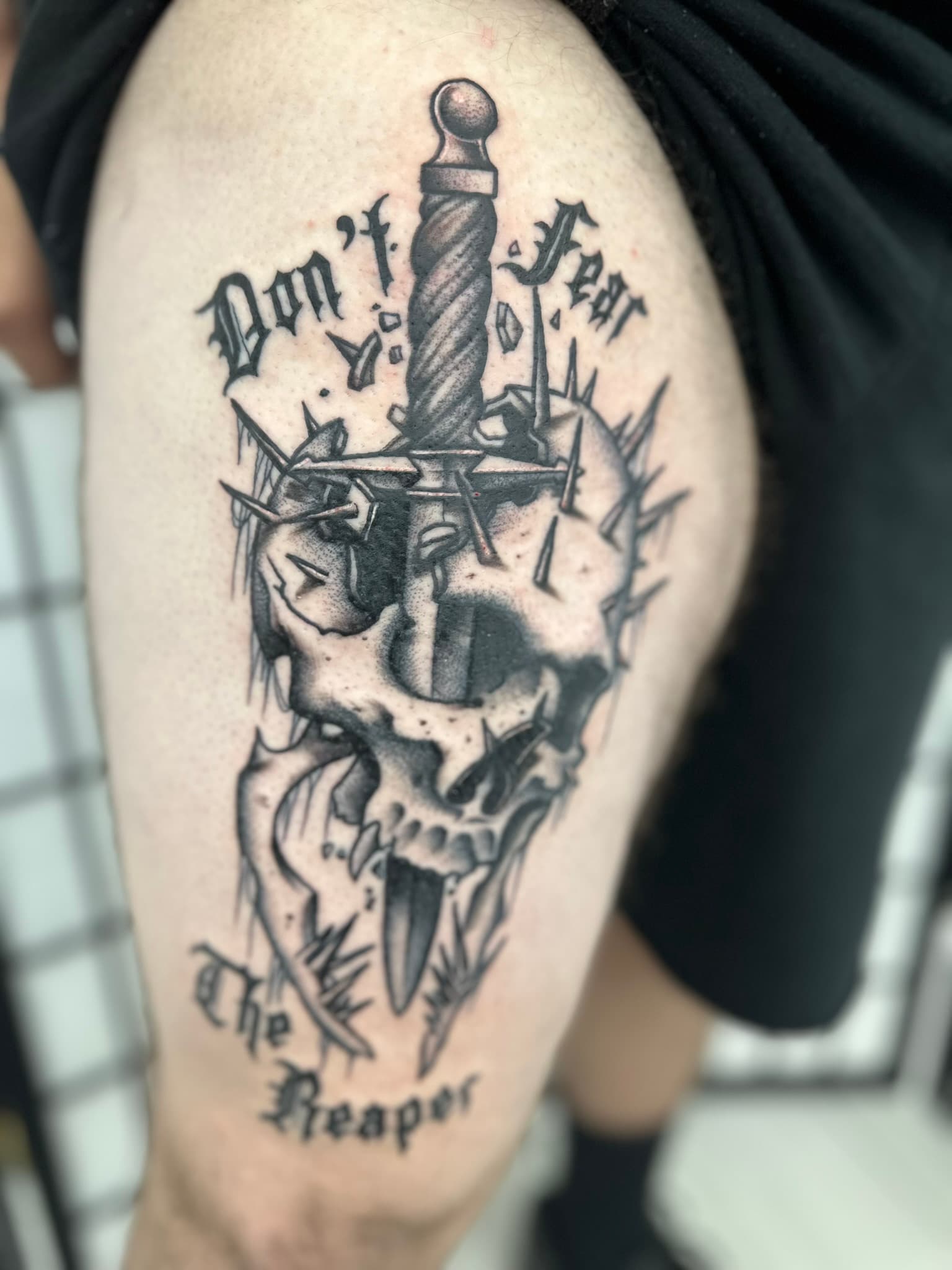 Custom music-themed skull and dagger tattoo by Isaac Mackenzie