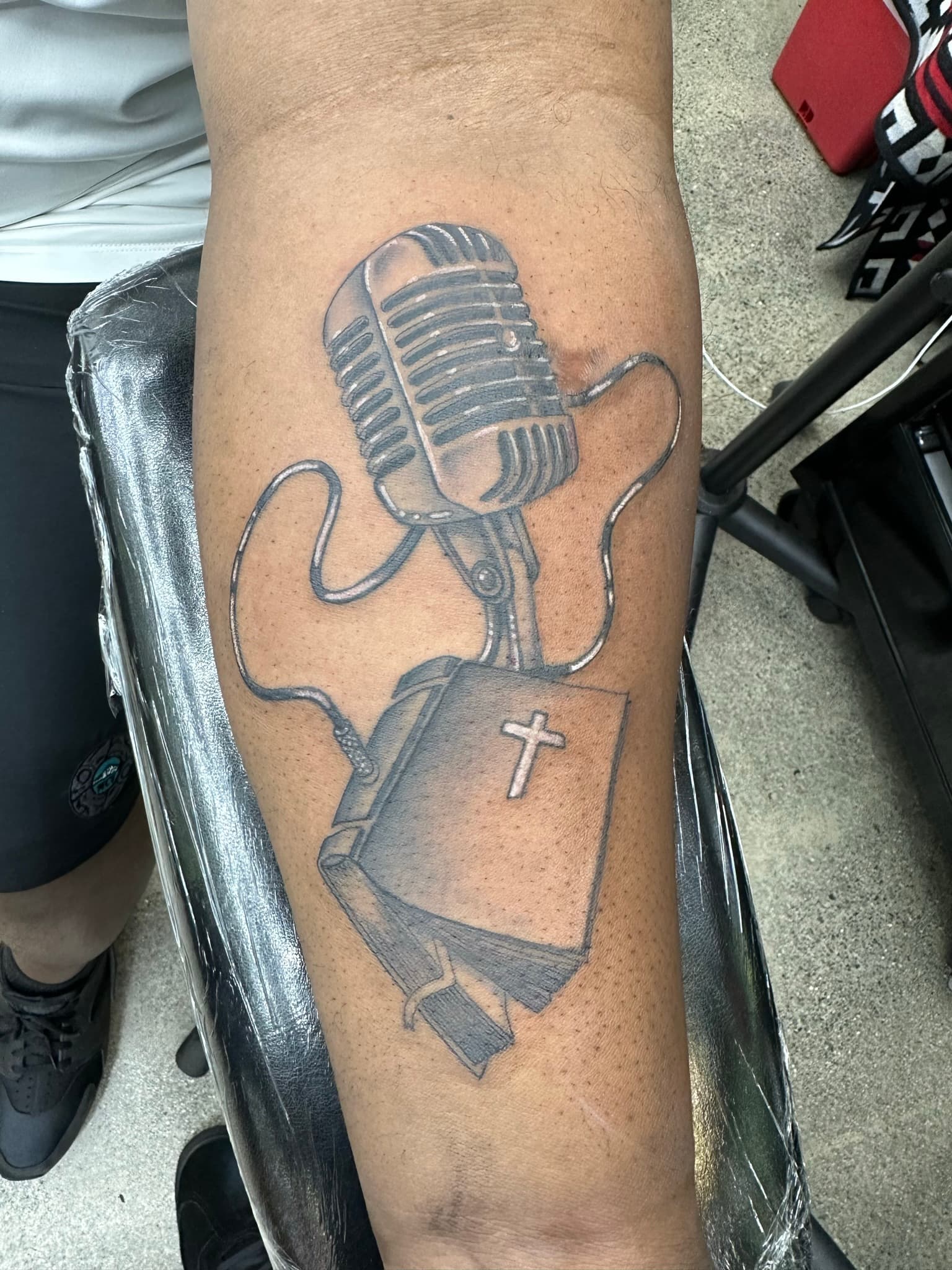 Custom vintage microphone and Bible tattoo by Isaac Mackenzie, Oahu