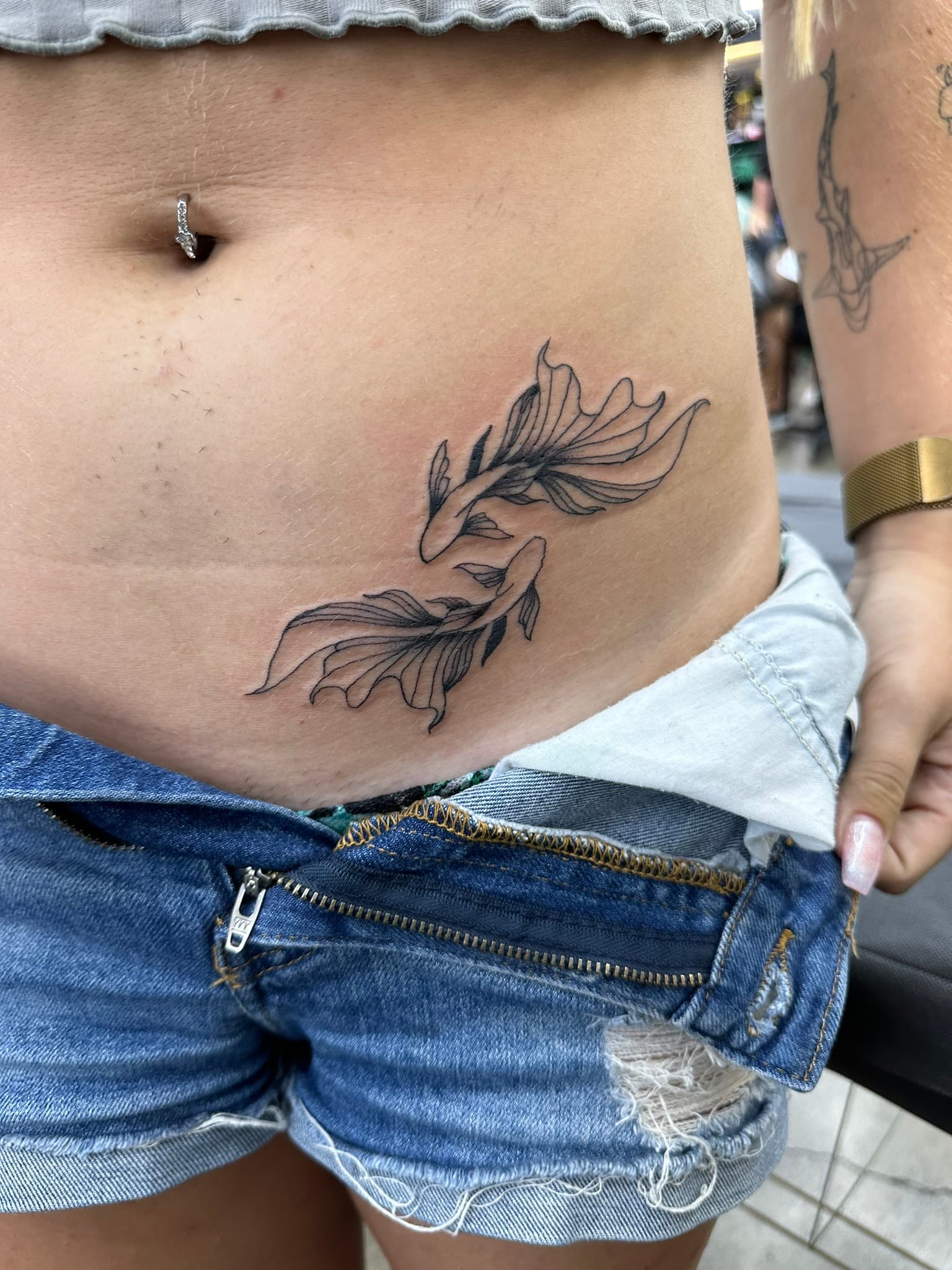 Fine line angelfish duo hip tattoo by Isaac Mackenzie, Oahu