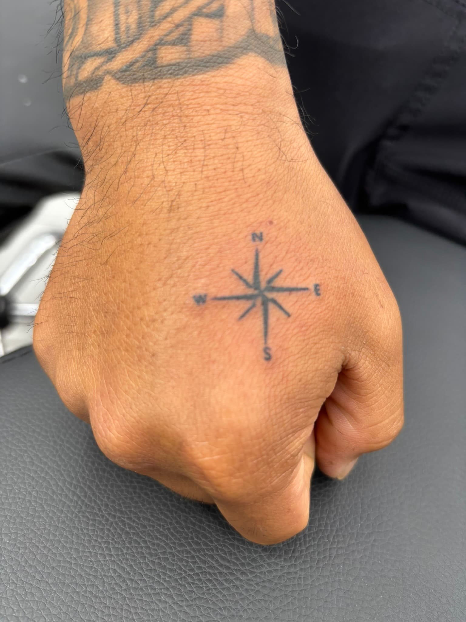 Fine line compass rose tattoo by Isaac Mackenzie, Hawaii