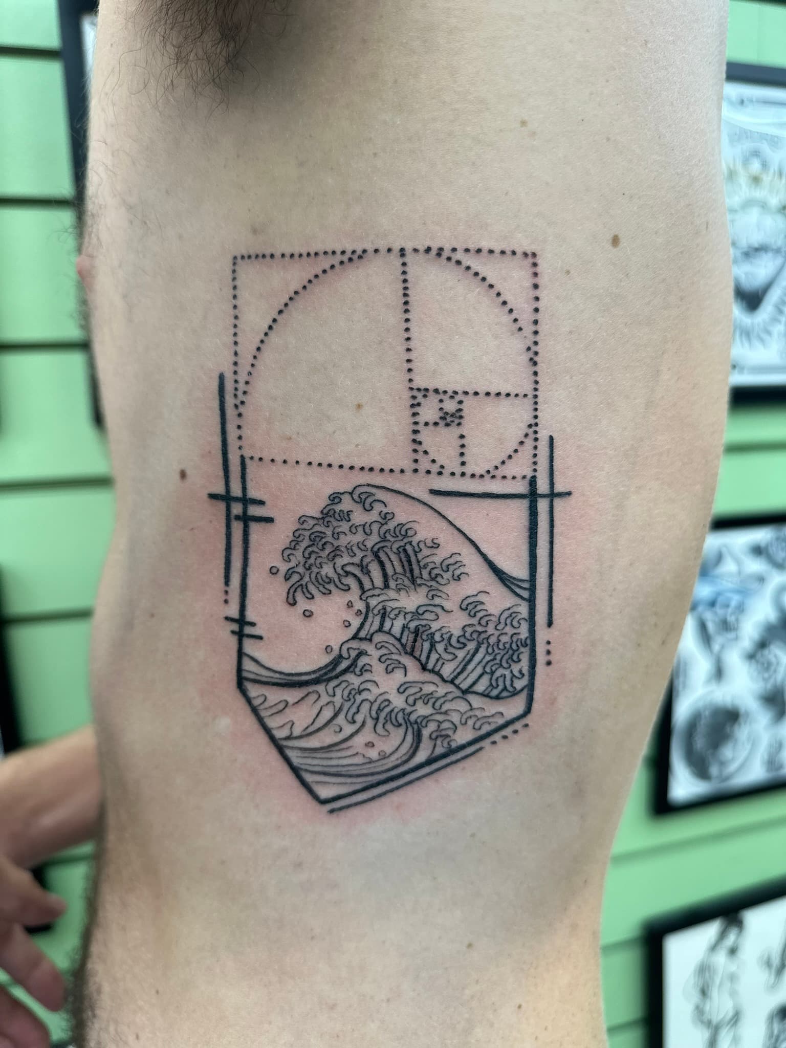 Fine line Fibonacci great wave tattoo by Isaac Mackenzie, Oahu Hawaii