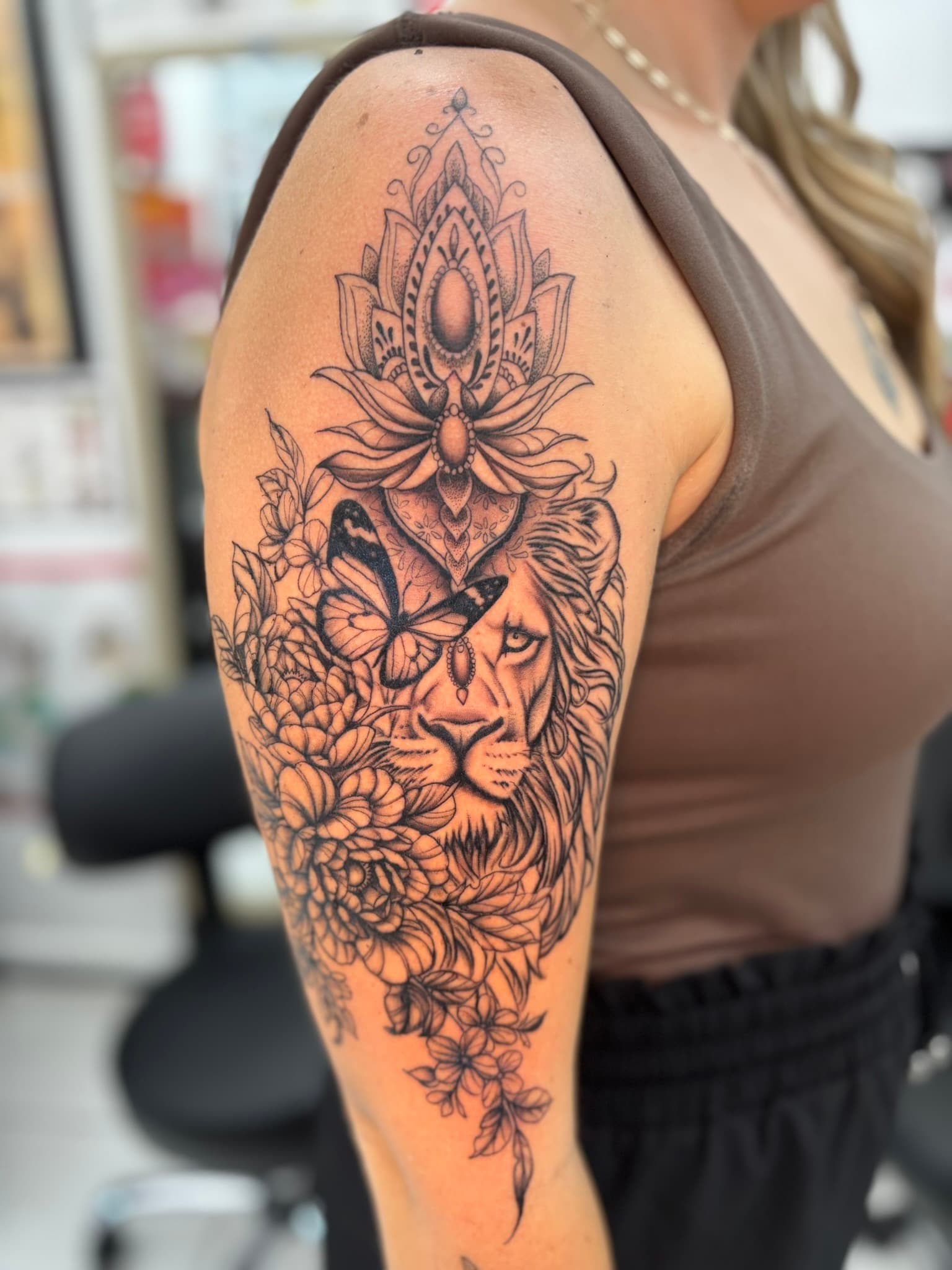 Fine line lion, butterfly, and floral mandala tattoo by Isaac Mackenzie at TNT Tattoo, Aiea, Oahu