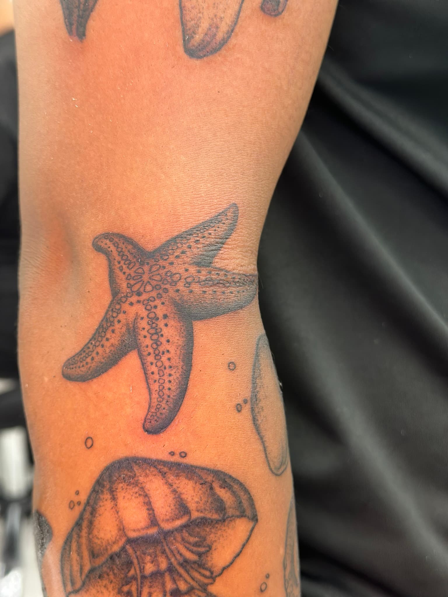 Fine line starfish, part of an aquatic sleeve, by Isaac Mackenzie