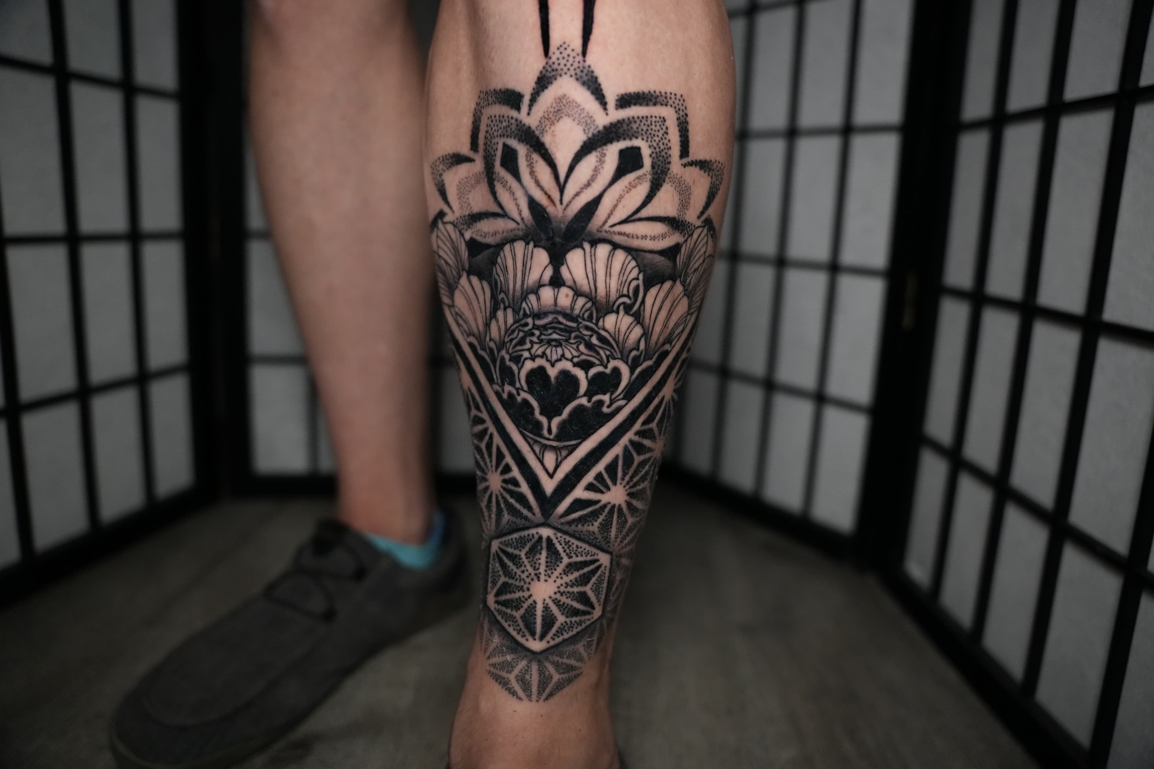 Geometric flower of life and lotus mandala tattoo by Isaac Mackenzie, Oahu