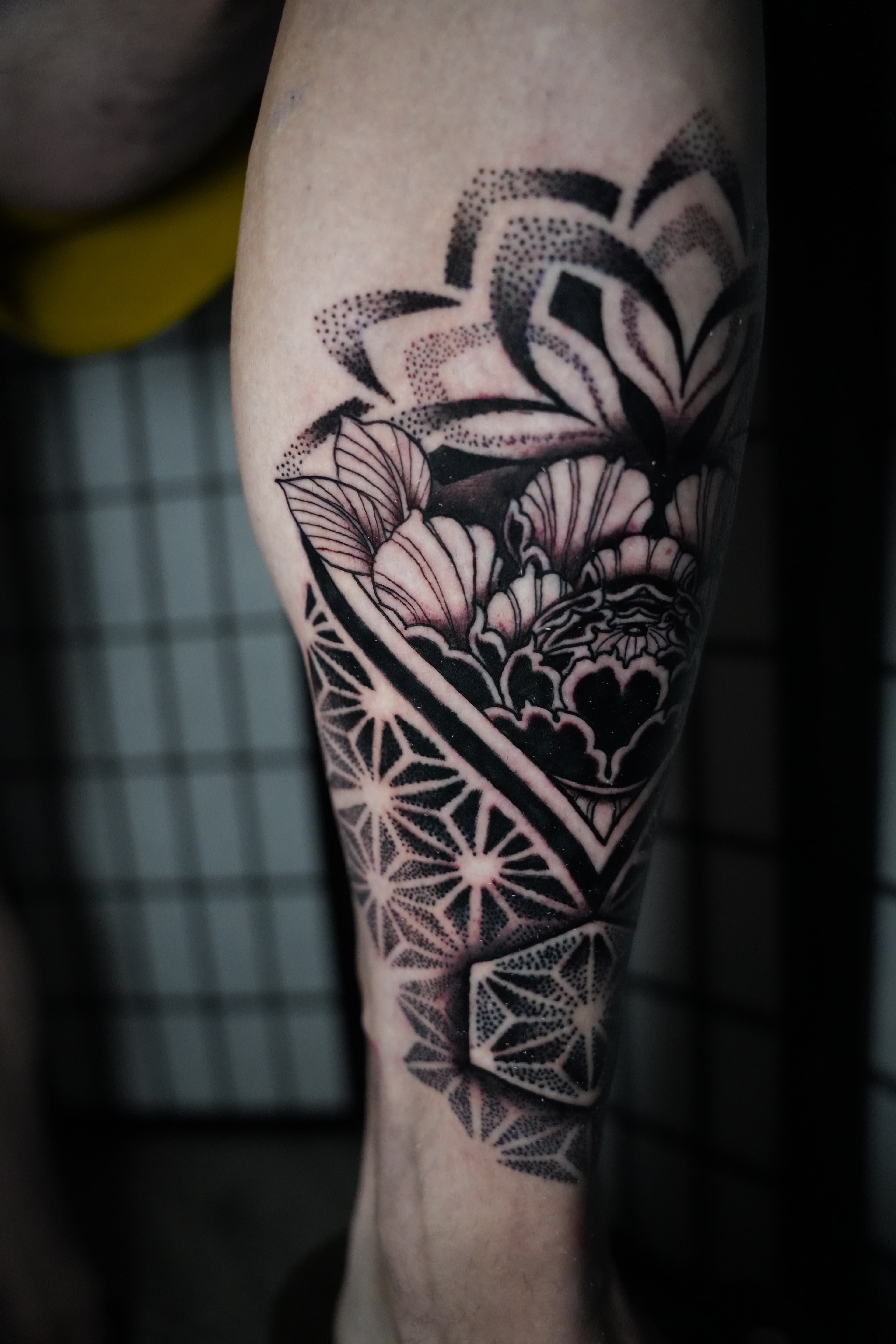 Geometric flower of life lotus mandala tattoo by Isaac Mackenzie, Hawaii