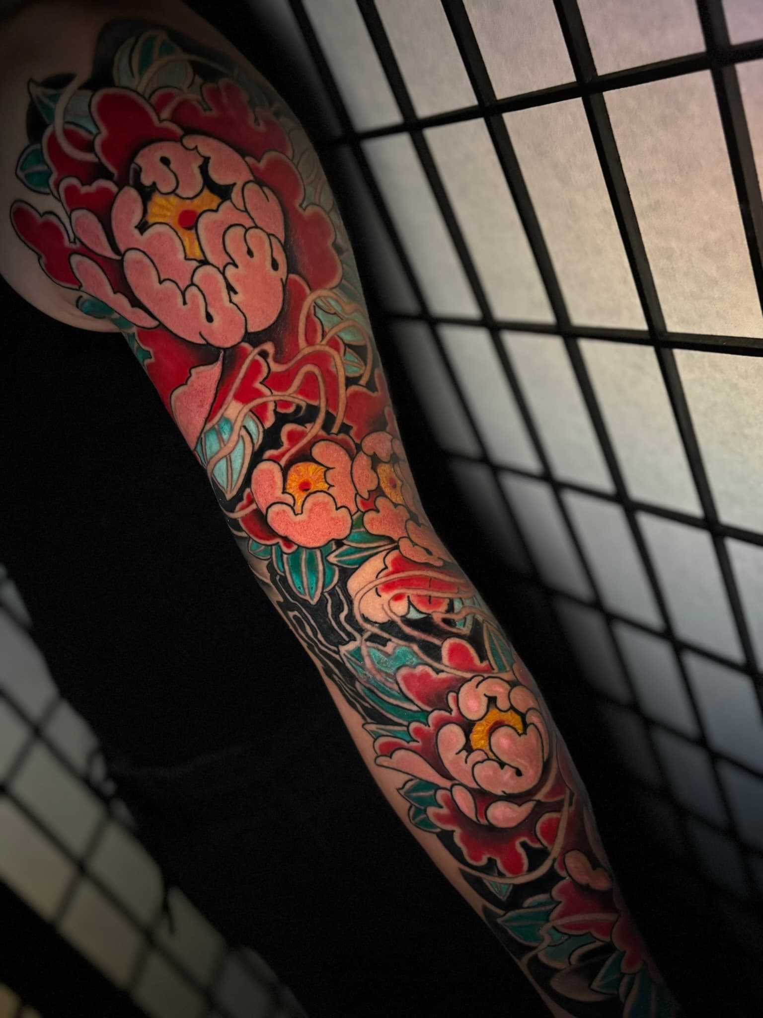 Japanese traditional peony color sleeve tattoo by Isaac Mackenzie, Oahu