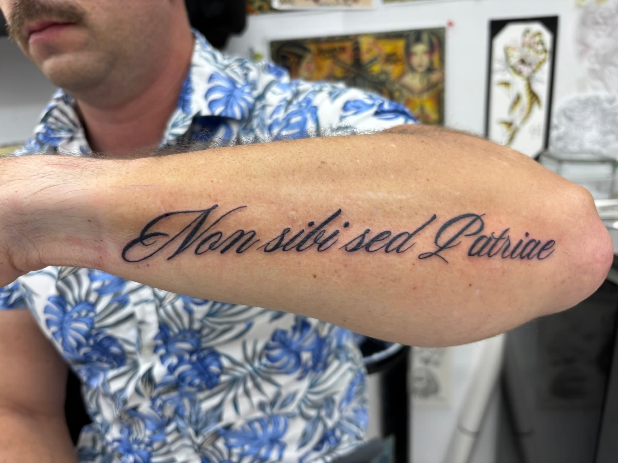 Script lettering tattoo running from wrist to elbow by Isaac Mackenzie, Oahu