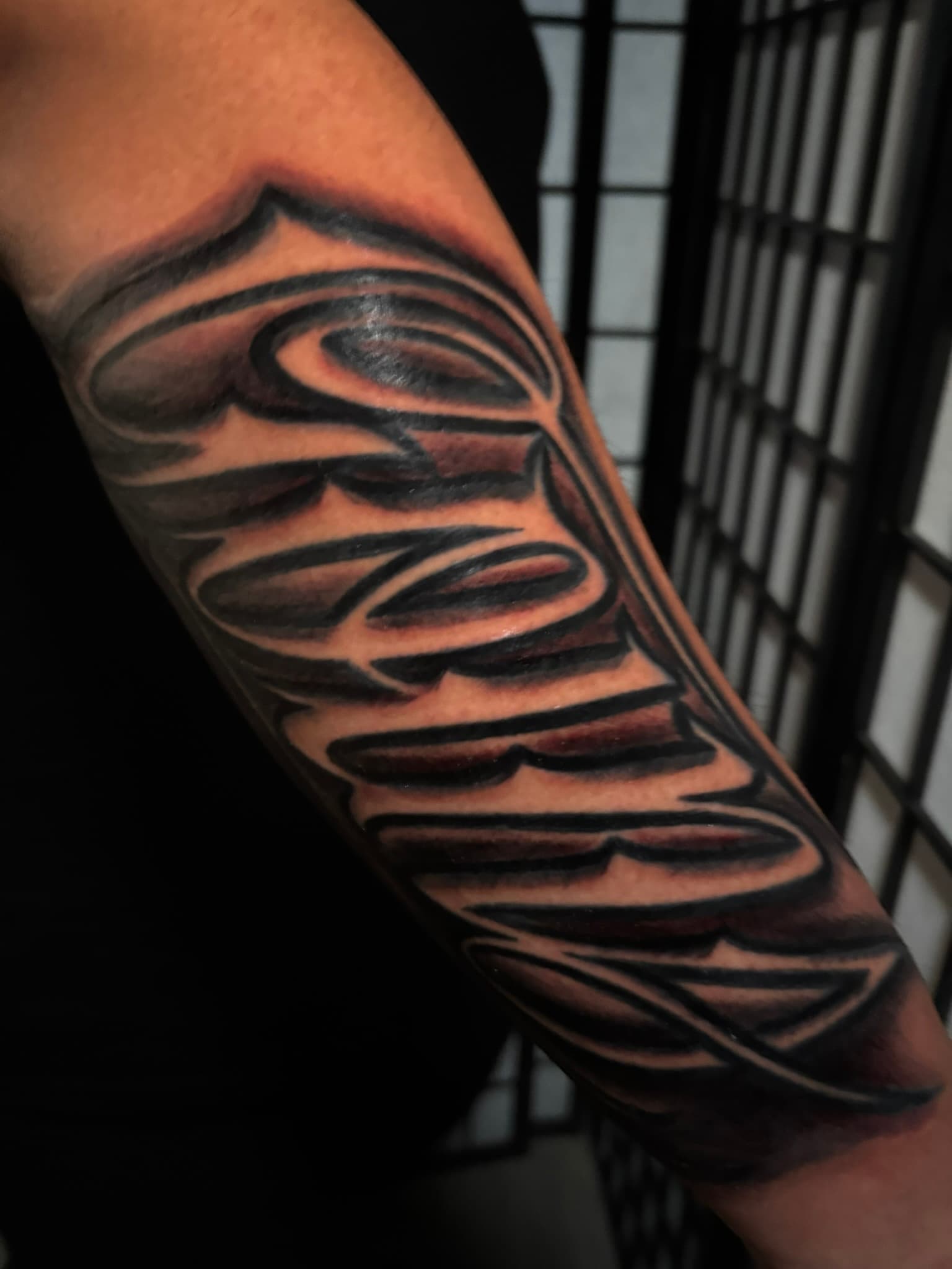 Lettering tattoo by Isaac Mackenzie at TNT Tattoo, Aiea