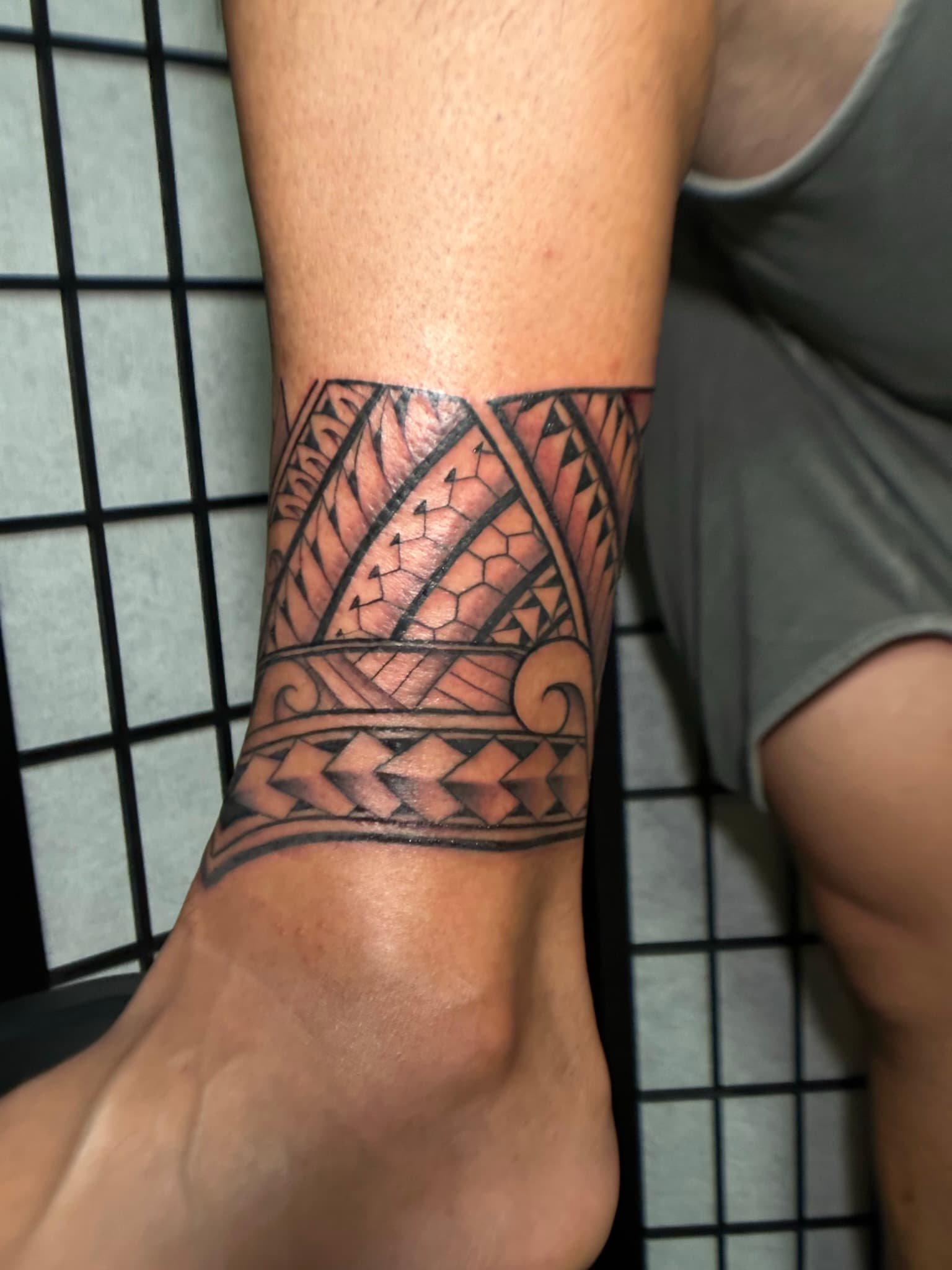 Custom Polynesian tribal ankle band tattoo by Isaac Mackenzie, Oahu