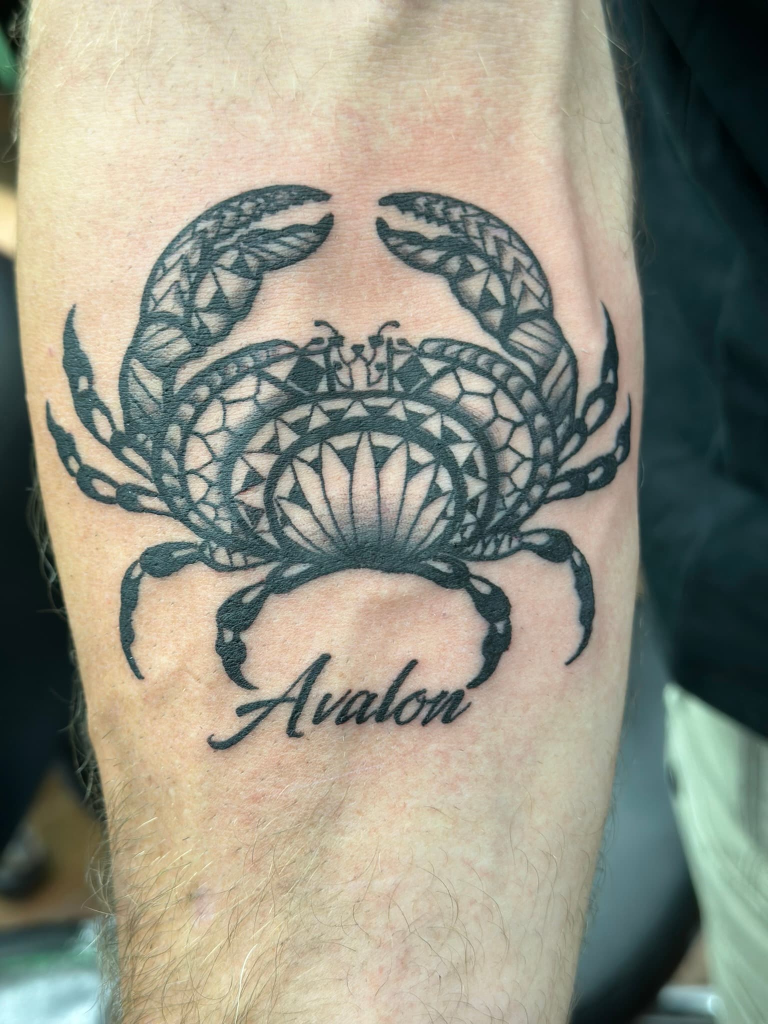 Custom Polynesian tribal crab with script tattoo by Isaac Mackenzie