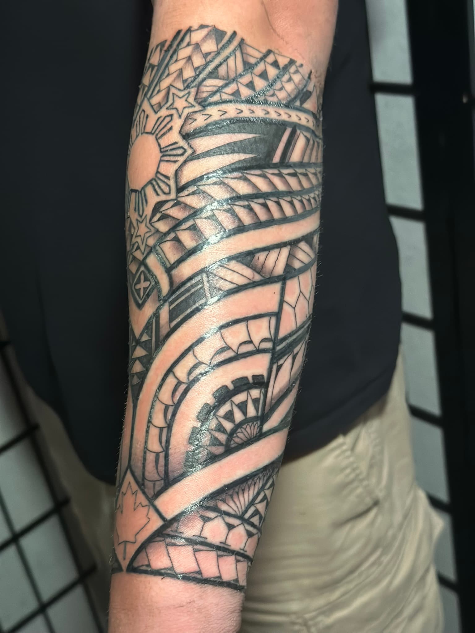 Custom Polynesian tribal half sleeve by Isaac Mackenzie, Hawaii