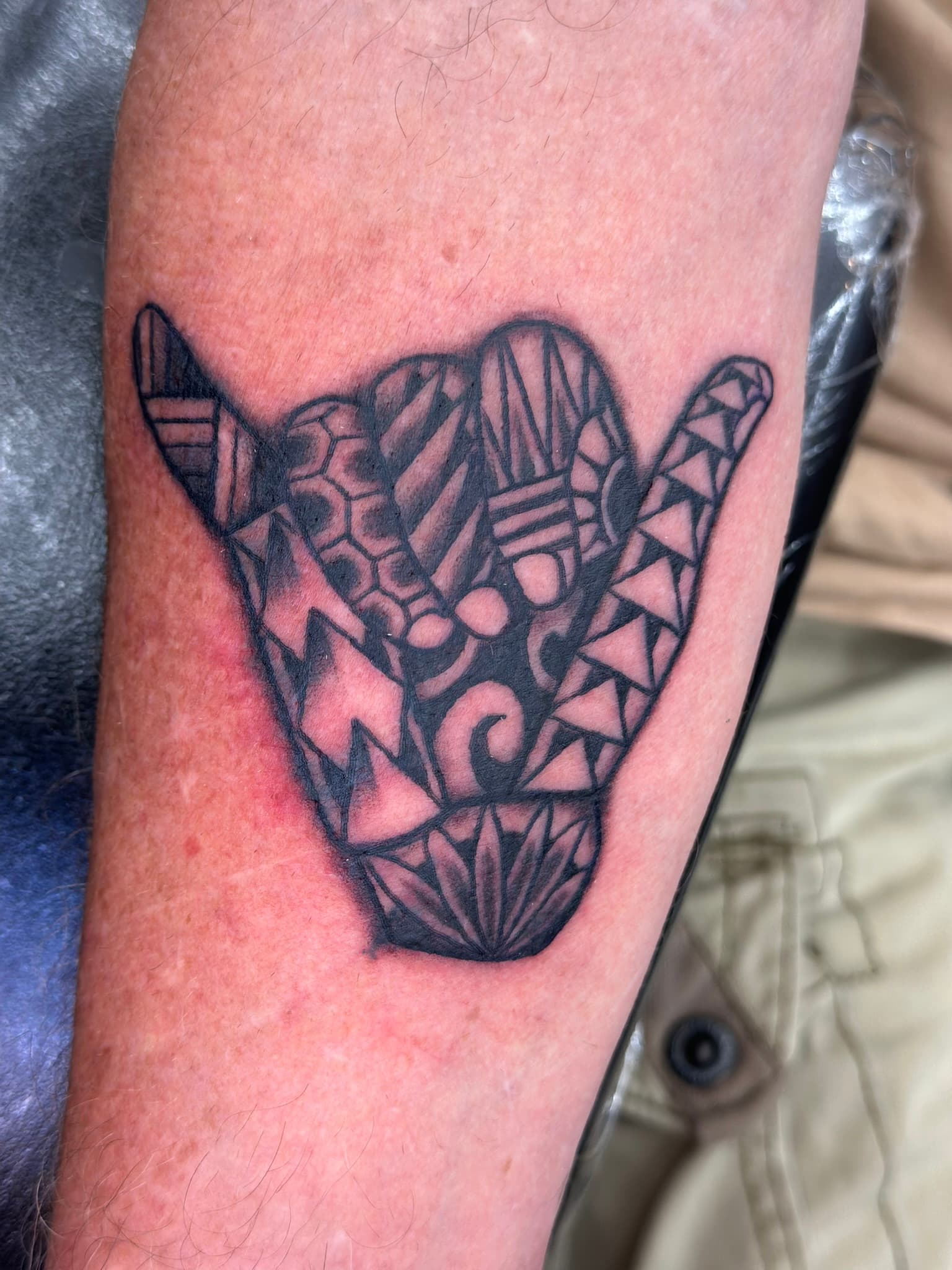 Custom Polynesian tribal shaka tattoo by Isaac Mackenzie, Hawaii