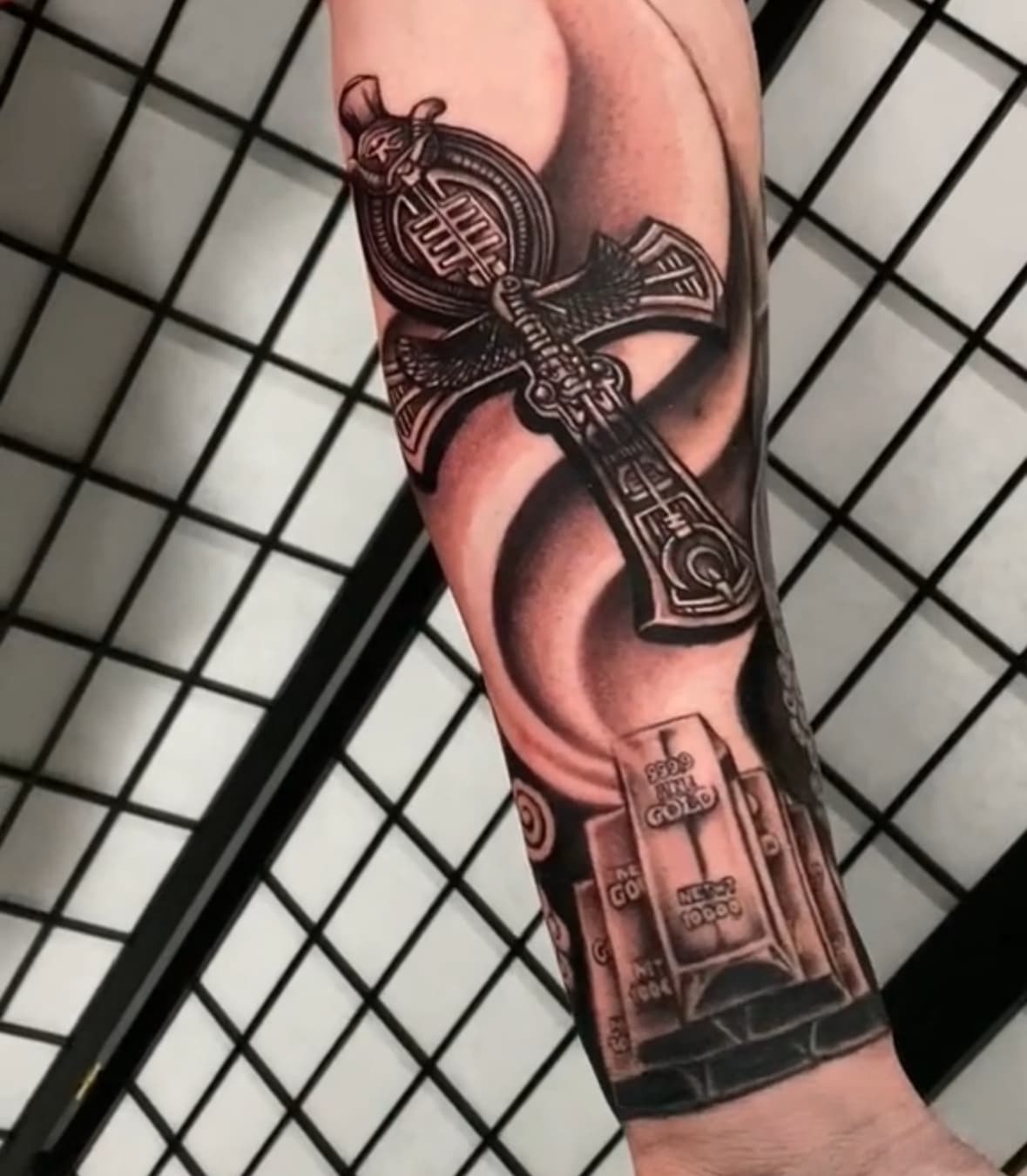 Realism Anubis with gold bars tattoo by Isaac Mackenzie