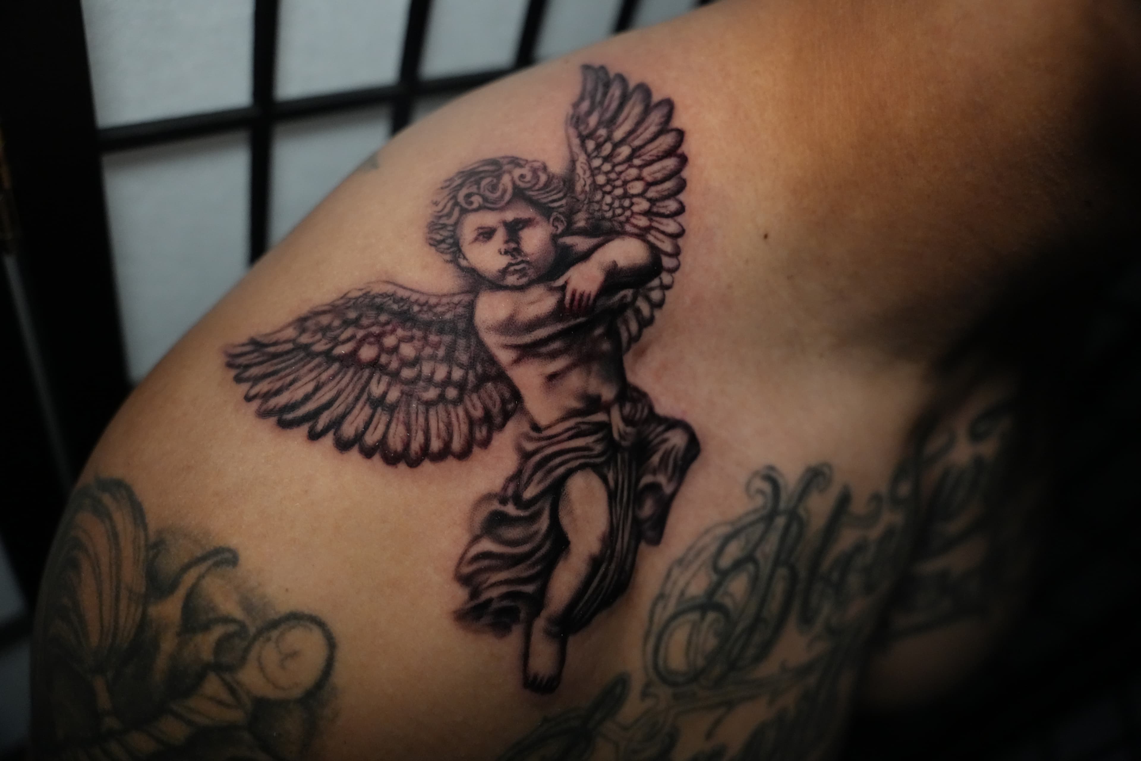 Realism cherub guardian angel tattoo by Isaac Mackenzie