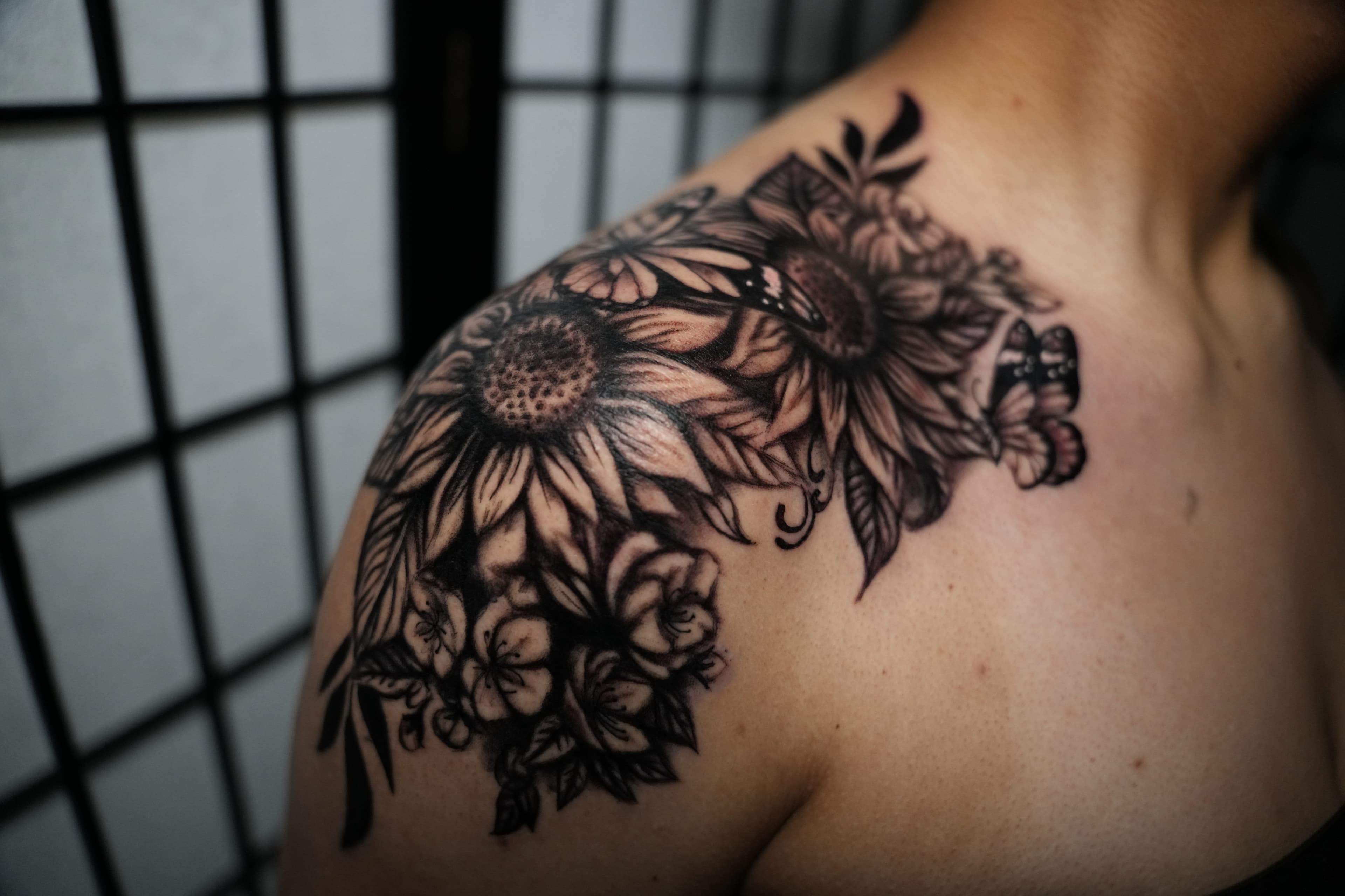 Realism sunflowers and butterfly tattoo by Isaac Mackenzie
