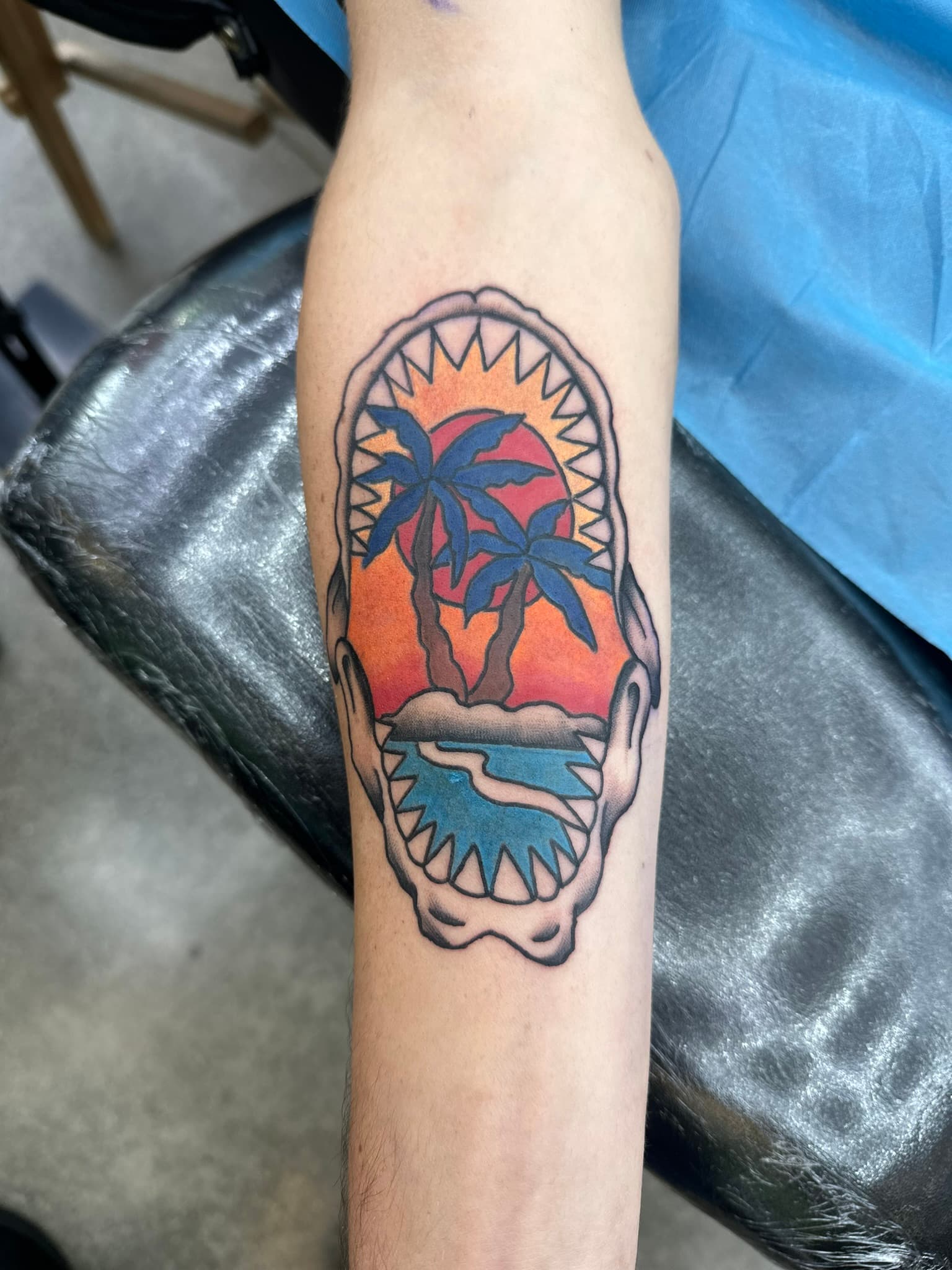 American traditional shark jaws with palm and sunset tattoo by Isaac Mackenzie at TNT Tattoo, Aiea, Oahu