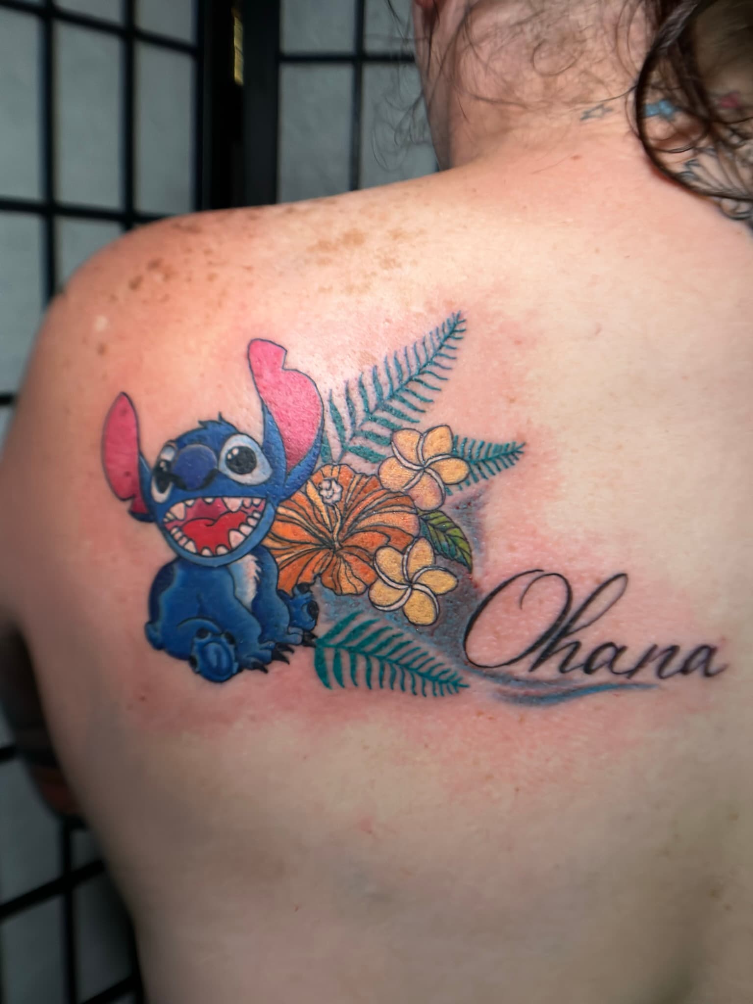 American traditional Stitch with Hawaiian florals tattoo by Isaac Mackenzie, Oahu